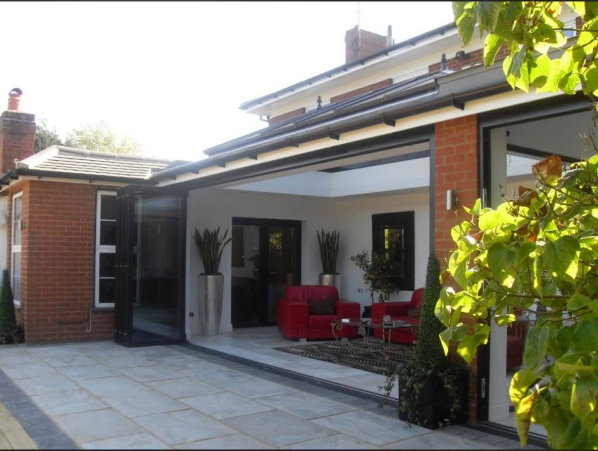 Custom home extension with bi-fold doors and patio